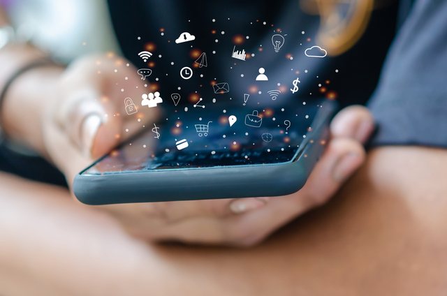 640 hand holding smartphone with icons